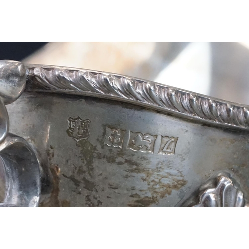 473 - Pair of silver sauce boats, gadroon border, scroll handle with cast acanthus leaf, three hoof feet w... 