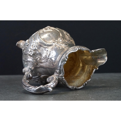 474 - Victorian silver jug, baluster form, stylised cast pie crust border, repoussé floral and foliate dec... 