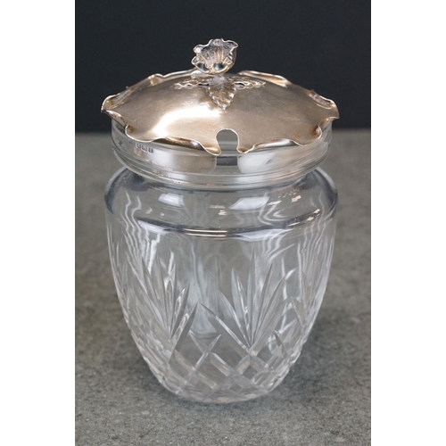 479 - Edwardian silver lidded cut glass preserve pot, the lid with scalloped folded border, cast flower he... 