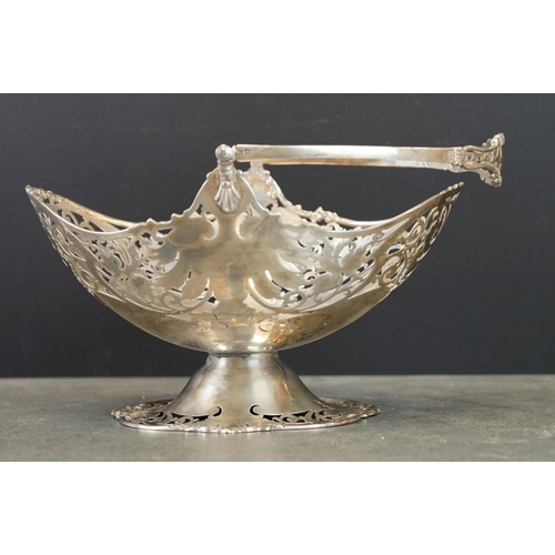 492 - George V Silver footed oval fruit basket with swing handle, pierced scrolling decoration and vacant ... 