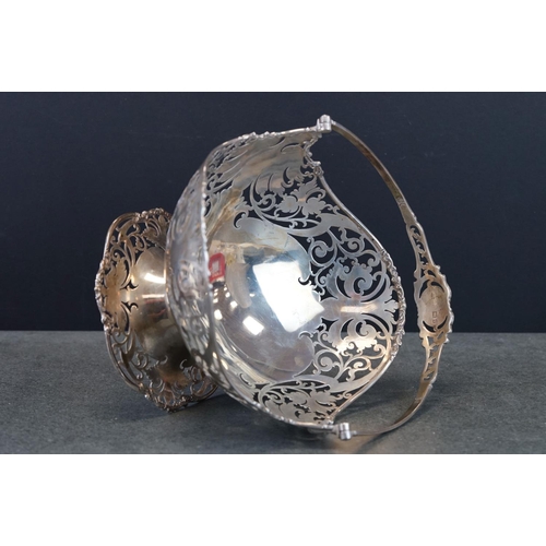 492 - George V Silver footed oval fruit basket with swing handle, pierced scrolling decoration and vacant ... 