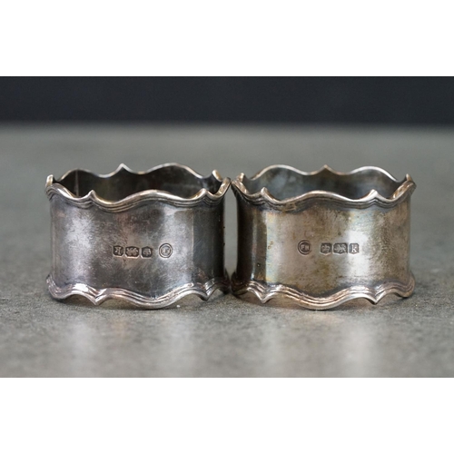 493 - Boxed set of two George V silver napkin rings with ribbed borders, engraved initials to front, Sheff... 