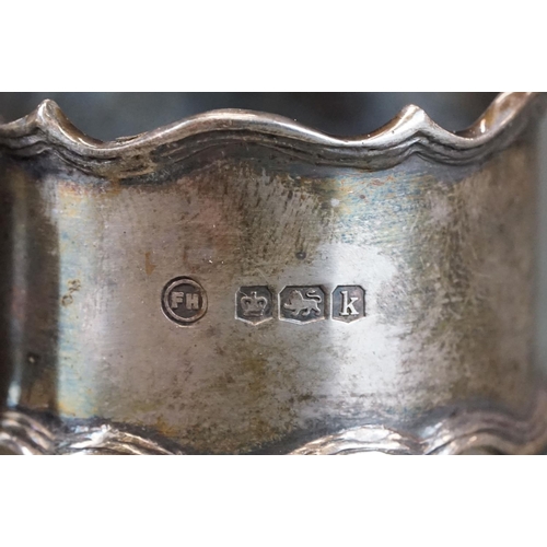 493 - Boxed set of two George V silver napkin rings with ribbed borders, engraved initials to front, Sheff... 