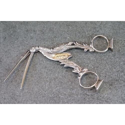 500 - Pair of Victorian silver ribbon puller stork scissors, with a serpent wrapped around its neck and be... 