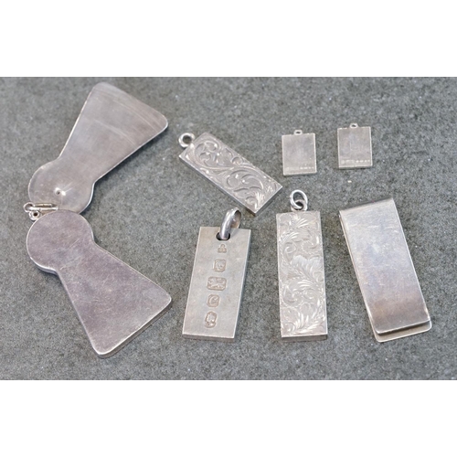 502 - Group of silver items to include a novelty pendant in the form of an escutcheon, opening to reveal a... 