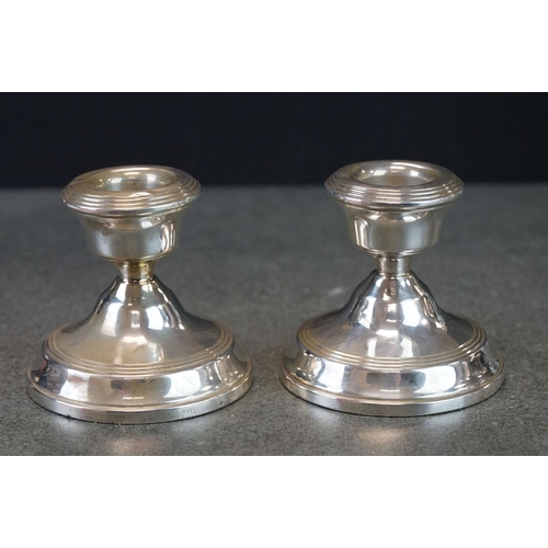 506 - Two pairs of silver candlesticks to include a pair of 1957 Birmingham silver candlesticks of plain p... 