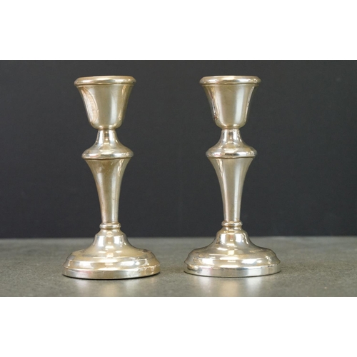 506 - Two pairs of silver candlesticks to include a pair of 1957 Birmingham silver candlesticks of plain p... 