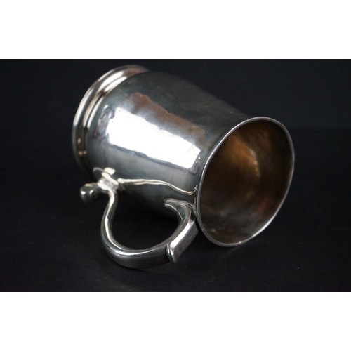 515 - George II silver tankard of plain polished form with moulded rim, foot rim and scrolling handle, mon... 