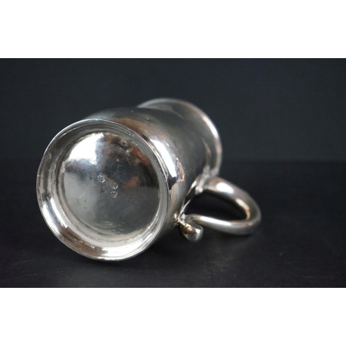 515 - George II silver tankard of plain polished form with moulded rim, foot rim and scrolling handle, mon... 