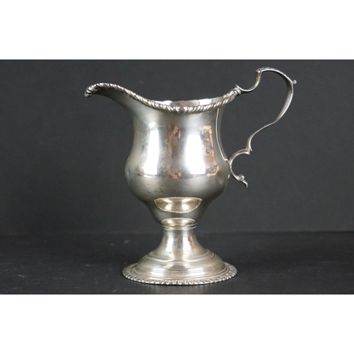 516 - Late Victorian silver tankard of tapered form, with engraved floral decoration, scrolling handle and... 