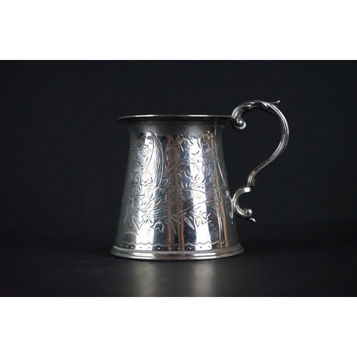 516 - Late Victorian silver tankard of tapered form, with engraved floral decoration, scrolling handle and... 