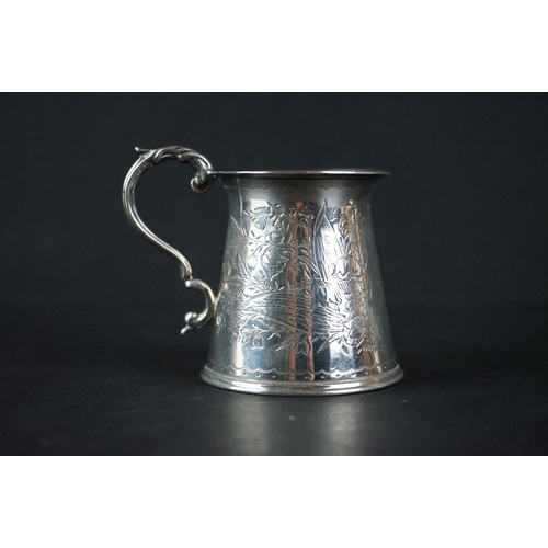 516 - Late Victorian silver tankard of tapered form, with engraved floral decoration, scrolling handle and... 