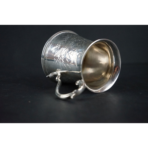 516 - Late Victorian silver tankard of tapered form, with engraved floral decoration, scrolling handle and... 