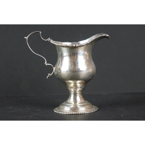 516 - Late Victorian silver tankard of tapered form, with engraved floral decoration, scrolling handle and... 