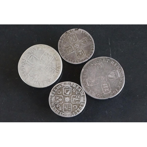 14 - A collection of four British pre decimal early milled silver coins to include King George II and Kin... 