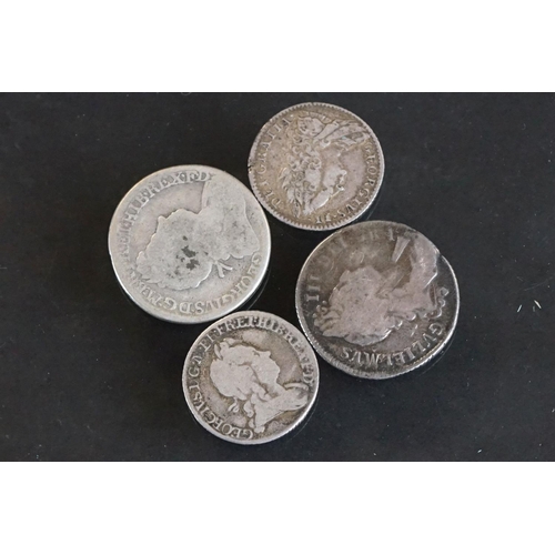 14 - A collection of four British pre decimal early milled silver coins to include King George II and Kin... 