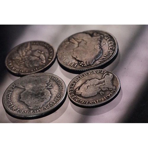 14 - A collection of four British pre decimal early milled silver coins to include King George II and Kin... 