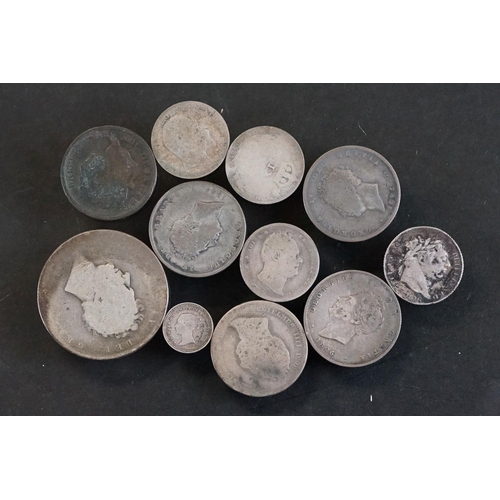 27 - A small collection of early milled British pre decimal silver coins to include George III examples.