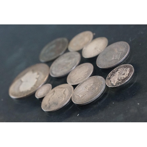 27 - A small collection of early milled British pre decimal silver coins to include George III examples.