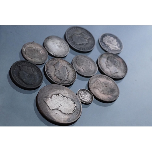 27 - A small collection of early milled British pre decimal silver coins to include George III examples.