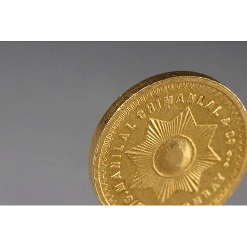 169 - An Indian Fine Gold 5 Tolas coin, Manilal Chimanlal & Co, Bombay. 8-pointed radiant star to verso.