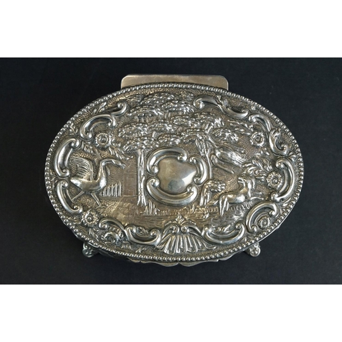 523 - Late Victorian silver lidded trinket box, the hinged lid with repoussé bird and animal decoration, f... 