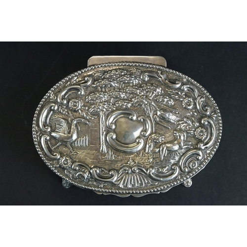 523 - Late Victorian silver lidded trinket box, the hinged lid with repoussé bird and animal decoration, f... 