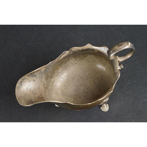 531 - George III silver sauce boat, pie crust border, scroll handle, plain polished body raised on three h... 