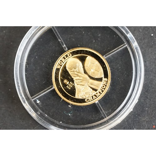 212 - A 'The Football World Champion' 14ct .585 gold collectors coin.