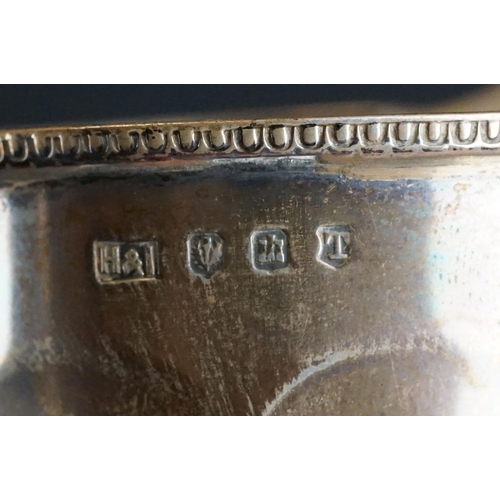 532 - Scottish silver milk jug, the faceted body raised on circular moulded foot, cast decoration to the r... 