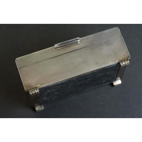 538 - Silver cigarette case, tapered ribbed thumbpiece to the hinged lid, engine turned decoration, the bo... 