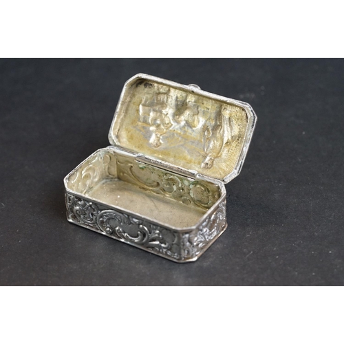 539 - Continental silver pill box, repoussé idyllic Shepherd and Shepherdess scene to the hinged lid, the ... 