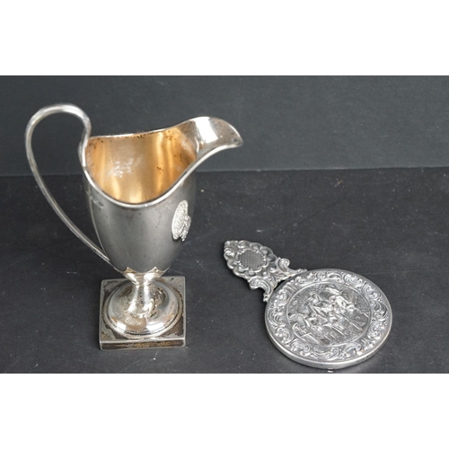 540 - Silver helmet shaped milk jug, the plain polished body raised on moulded circular foot to square ped... 