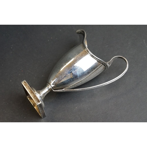 540 - Silver helmet shaped milk jug, the plain polished body raised on moulded circular foot to square ped... 