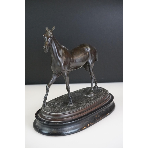 104 - Spelter figure of a horse mid-stride, mounted on a wooden base, approx 27cm high