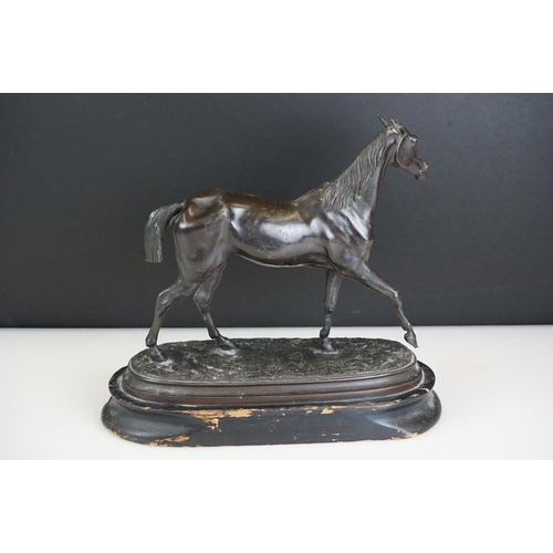 104 - Spelter figure of a horse mid-stride, mounted on a wooden base, approx 27cm high