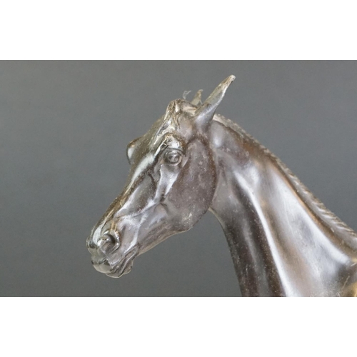 104 - Spelter figure of a horse mid-stride, mounted on a wooden base, approx 27cm high