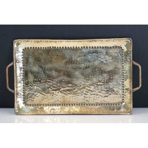 114 - John Pearson Arts & Crafts twin-handled hammered brass tray of rectangular form, impressed J.P to ba... 