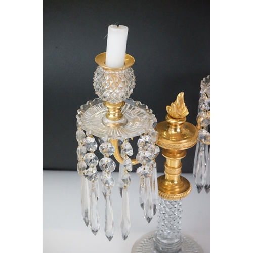 16 - Two early 20th Century cut glass and gilt metal two-branch candelabras, with cut glass stem and circ... 