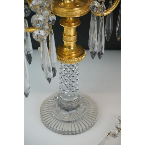 16 - Two early 20th Century cut glass and gilt metal two-branch candelabras, with cut glass stem and circ... 