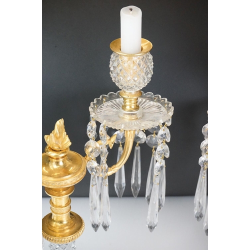 16 - Two early 20th Century cut glass and gilt metal two-branch candelabras, with cut glass stem and circ... 