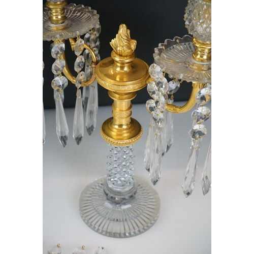 16 - Two early 20th Century cut glass and gilt metal two-branch candelabras, with cut glass stem and circ... 