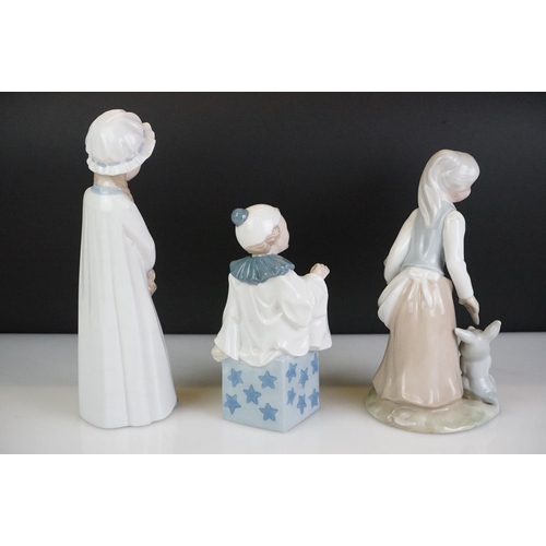 21 - Eight Spanish porcelain figures to include Nao by Lladro (boy holding a puppy, girl with basket of f... 