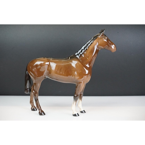 31 - Five Beswick horse figures to include a brown gloss shire horse with saddle, reins and harness (with... 