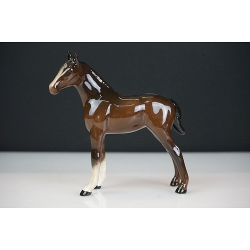 31 - Five Beswick horse figures to include a brown gloss shire horse with saddle, reins and harness (with... 