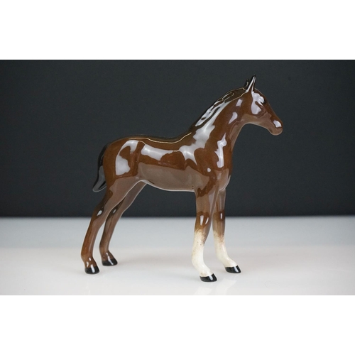 31 - Five Beswick horse figures to include a brown gloss shire horse with saddle, reins and harness (with... 