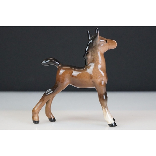 31 - Five Beswick horse figures to include a brown gloss shire horse with saddle, reins and harness (with... 