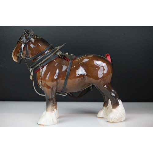 31 - Five Beswick horse figures to include a brown gloss shire horse with saddle, reins and harness (with... 