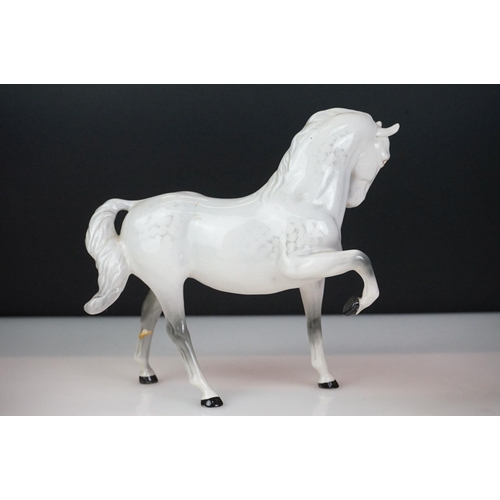 31 - Five Beswick horse figures to include a brown gloss shire horse with saddle, reins and harness (with... 