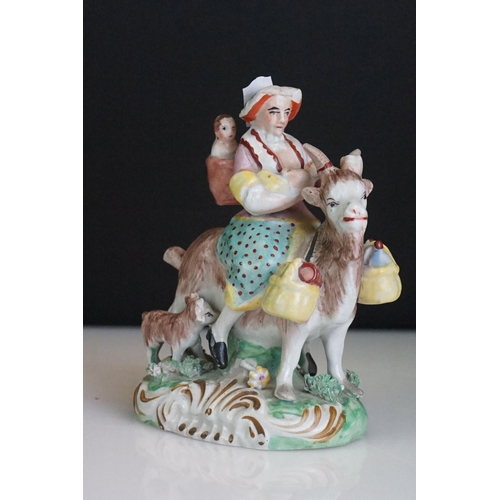 60 - Pair of 19th century Derby style figures, The Welch Tailor and Wife, he seated astride a goat, weari... 